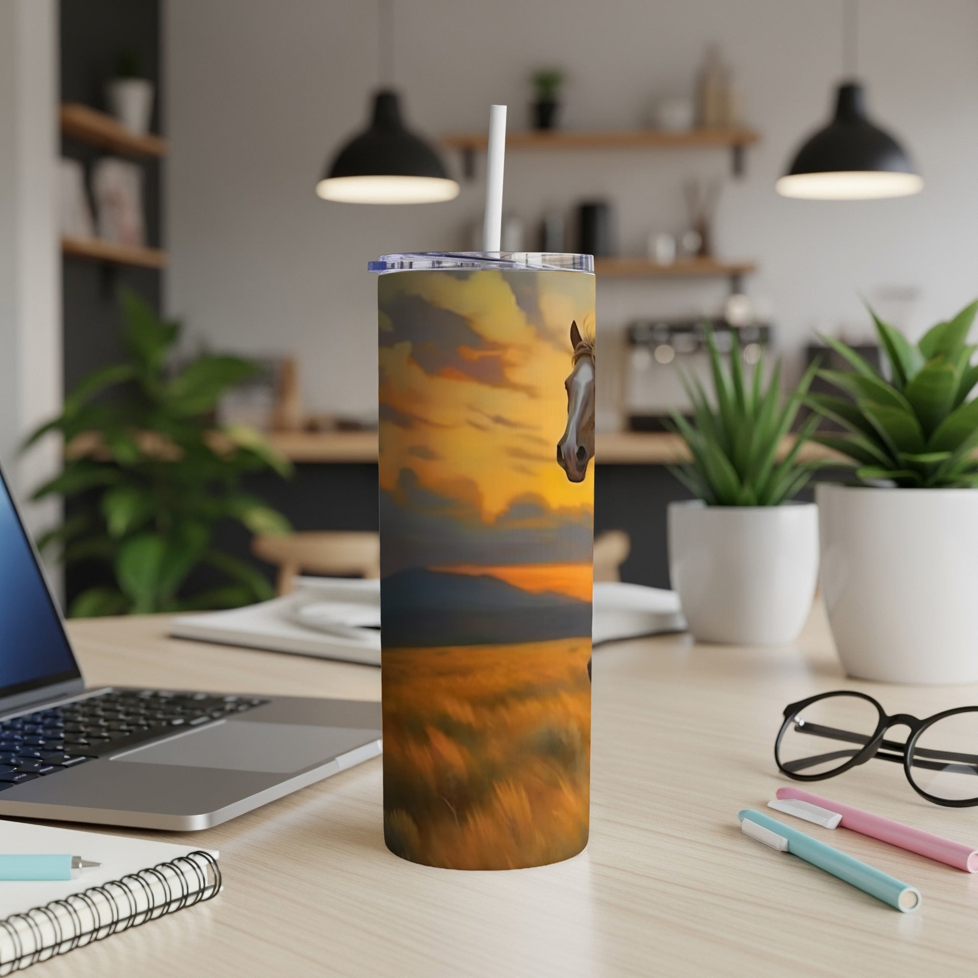 Horse head peeking over a field at sunset on a travel tumbler.