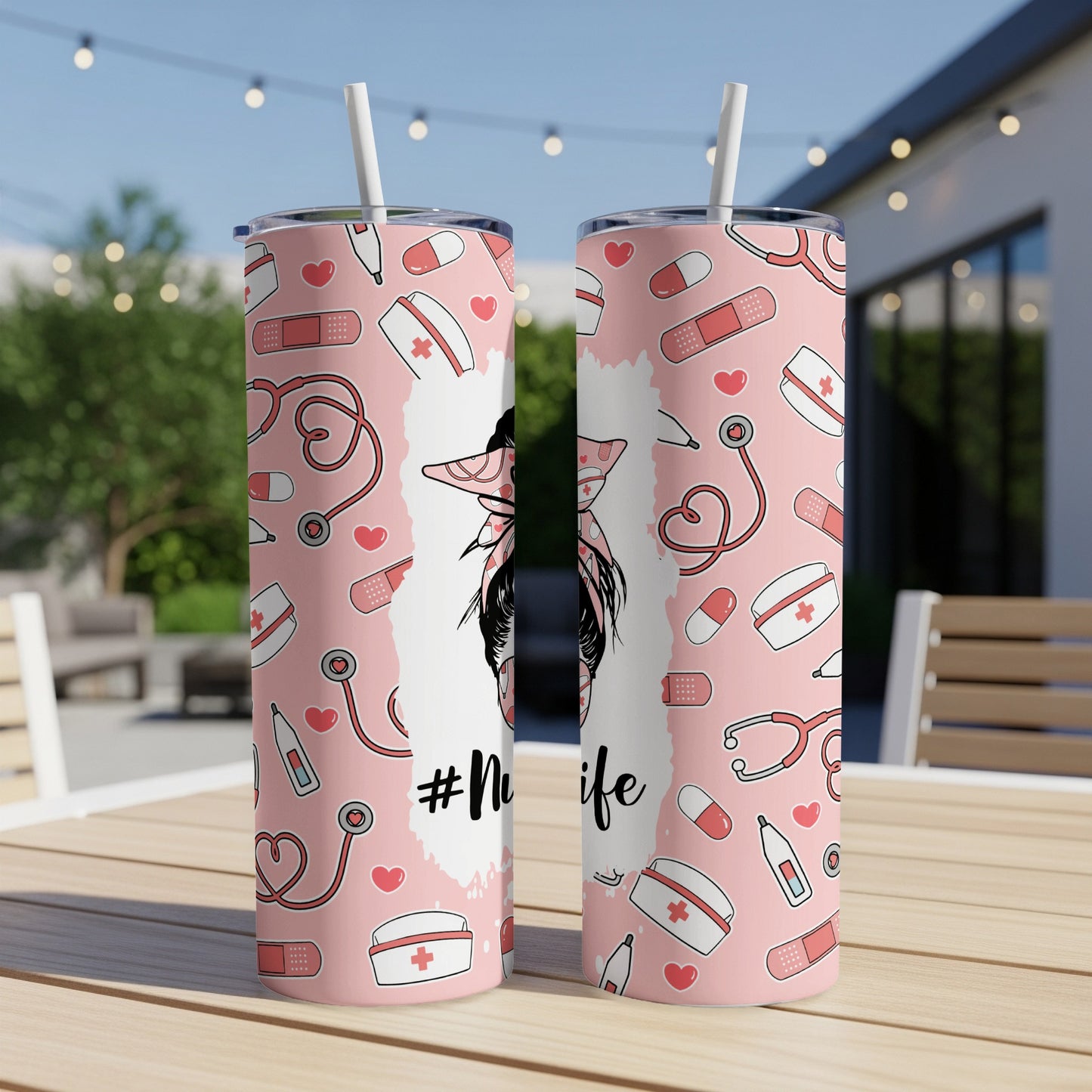 Two pink tumblers with "#Nurse life" and medical icons on a table.