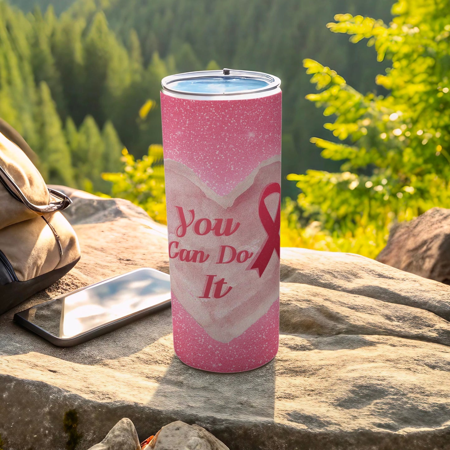 Pink tumbler with heart pattern, pink ribbon, and "You Can Do It" text.