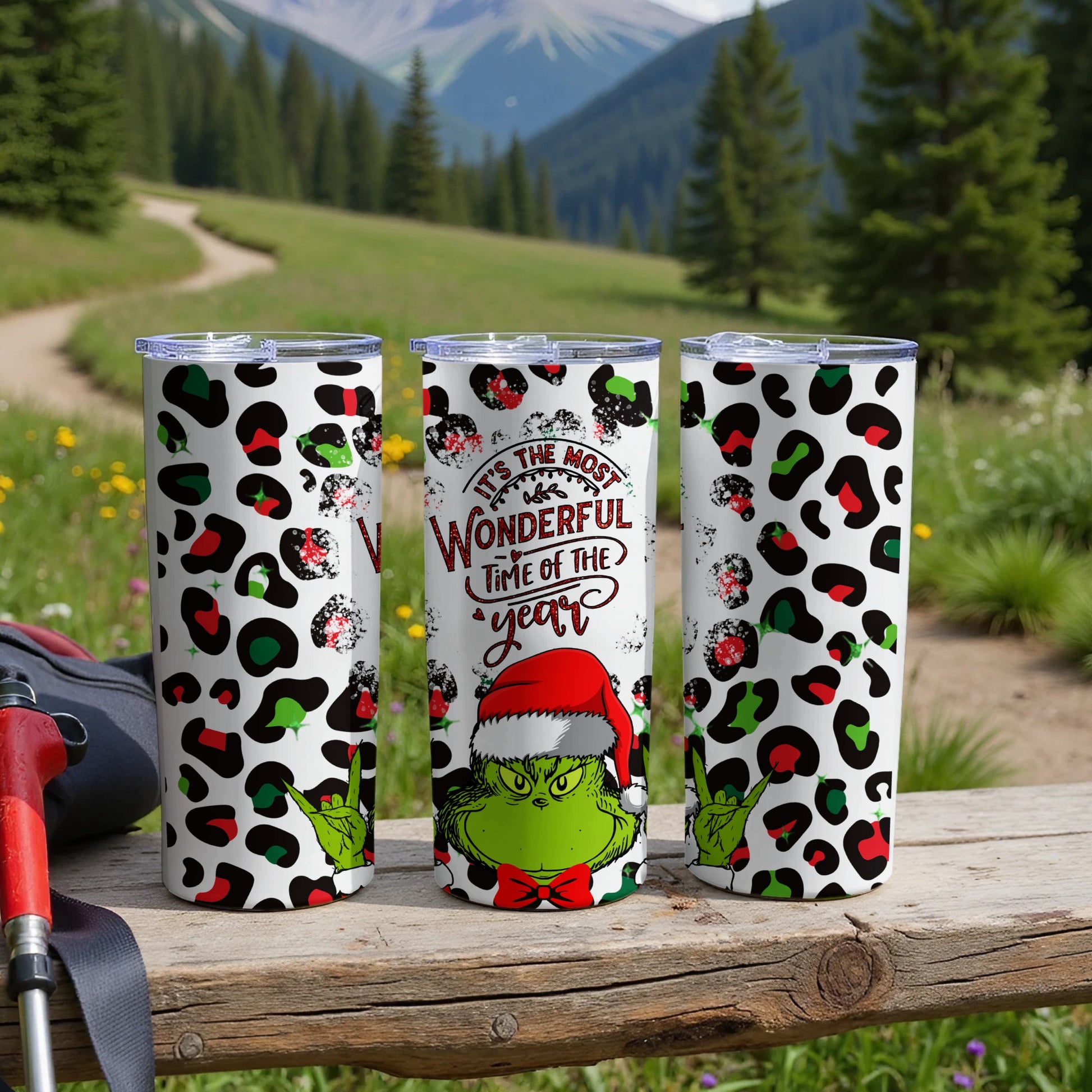 Three tumblers with Grinch and leopard print design.