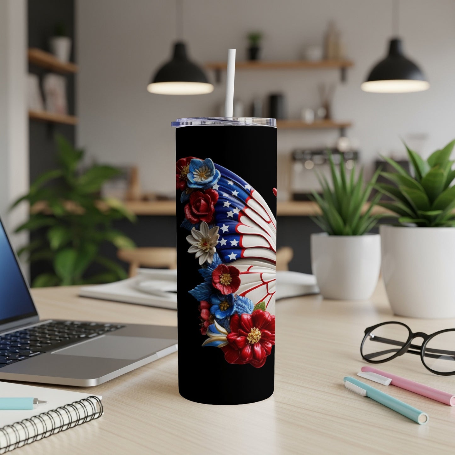 Black tumbler with patriotic butterfly wing design and white straw.