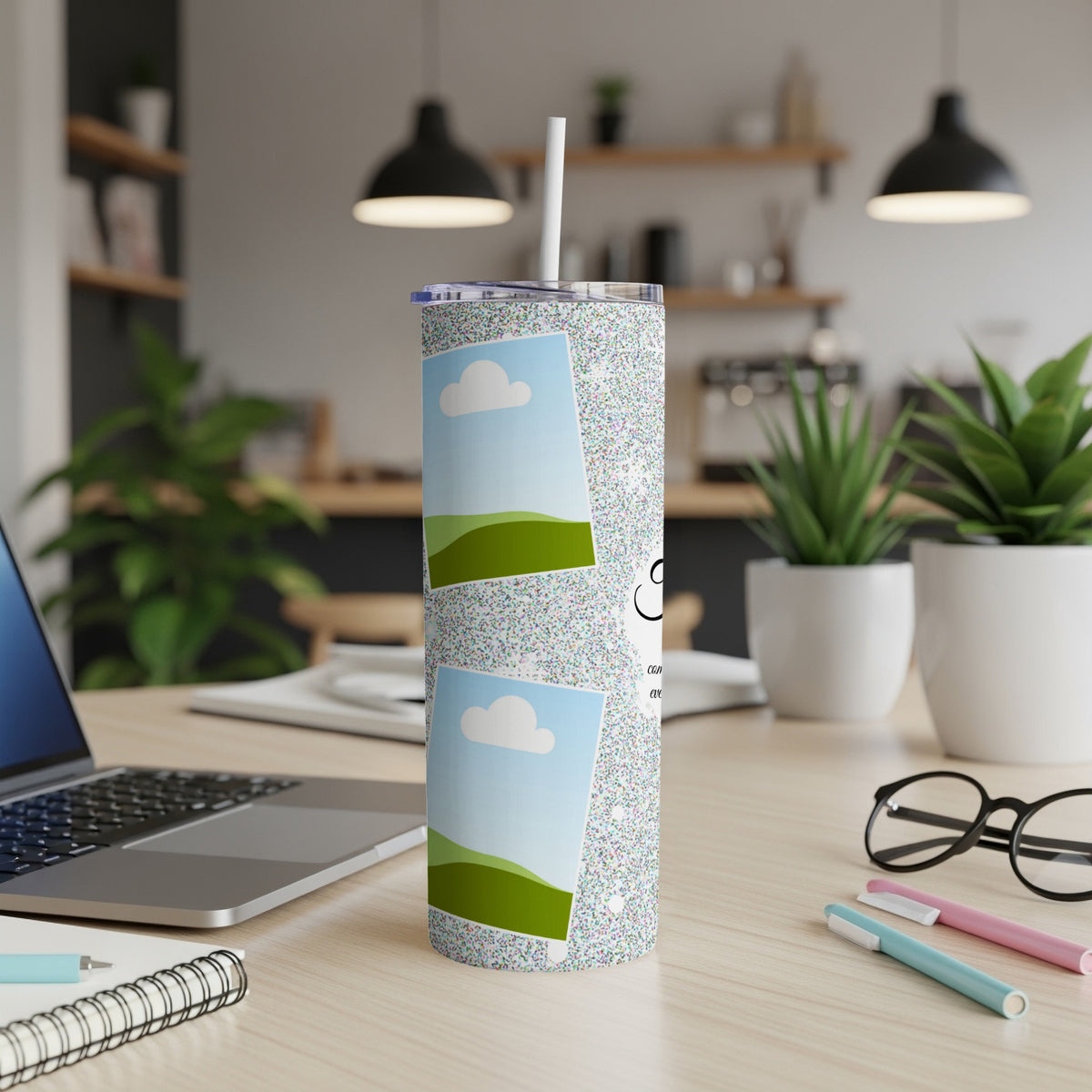 Glittery tumbler with two photo frames showing clouds and green hills.