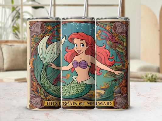 Ariel the mermaid with flowing red hair and green tail, surrounded by seaweed and coral.