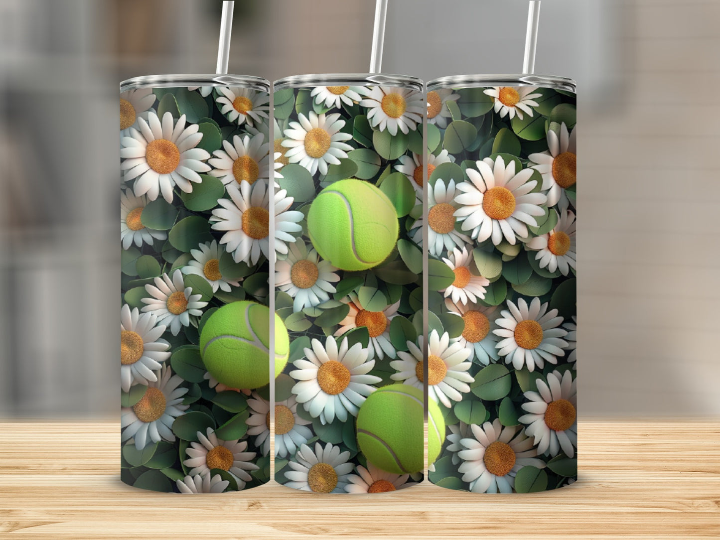 Three tumblers with a daisy and tennis ball pattern on a wooden surface.