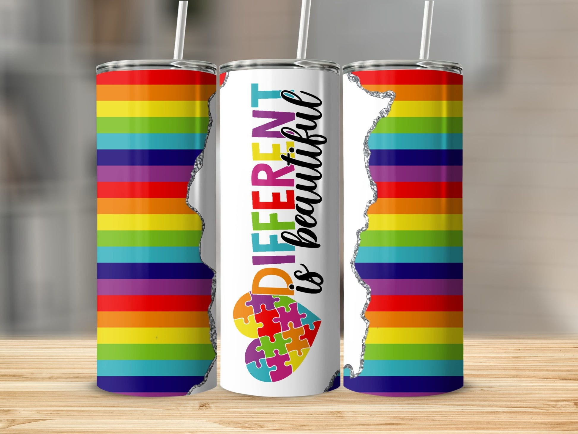 Tumbler with rainbow stripes and "Different is Beautiful" text with puzzle heart.