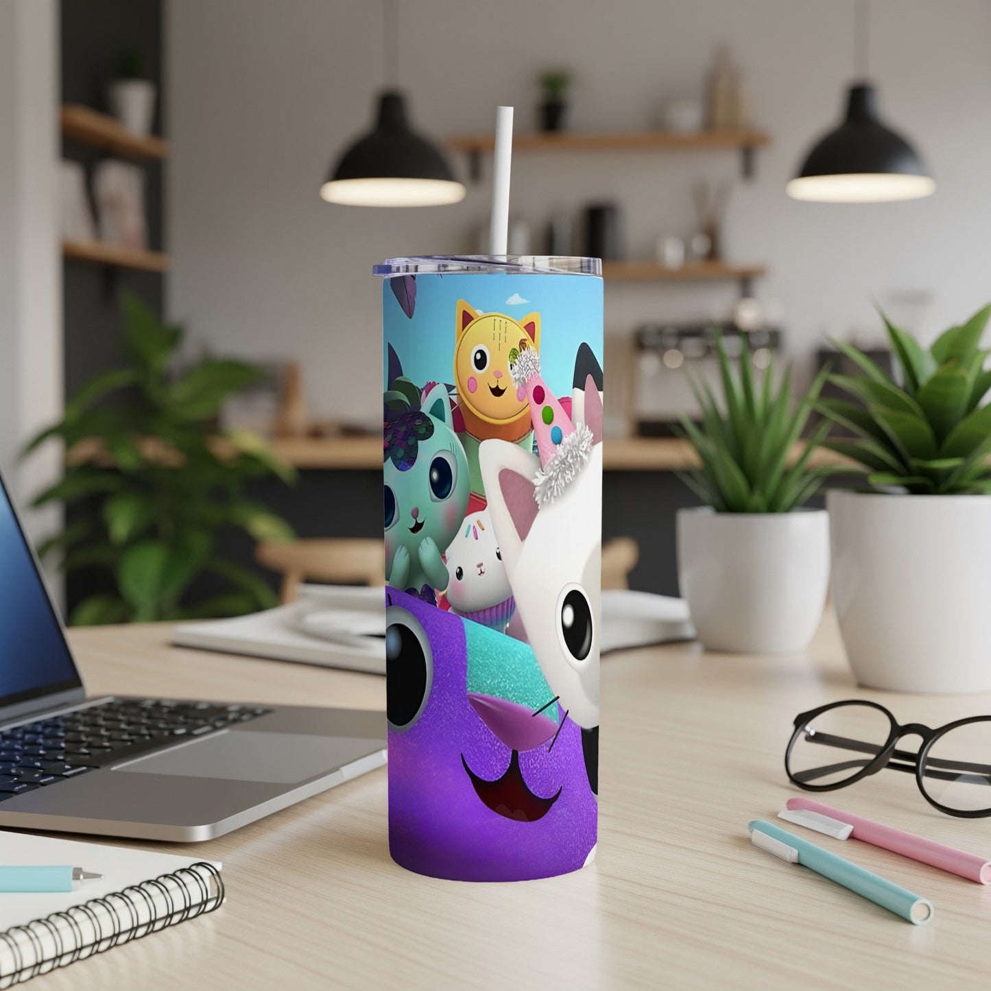 Purple creature with smiling face and cartoon characters on a stainless steel tumbler.