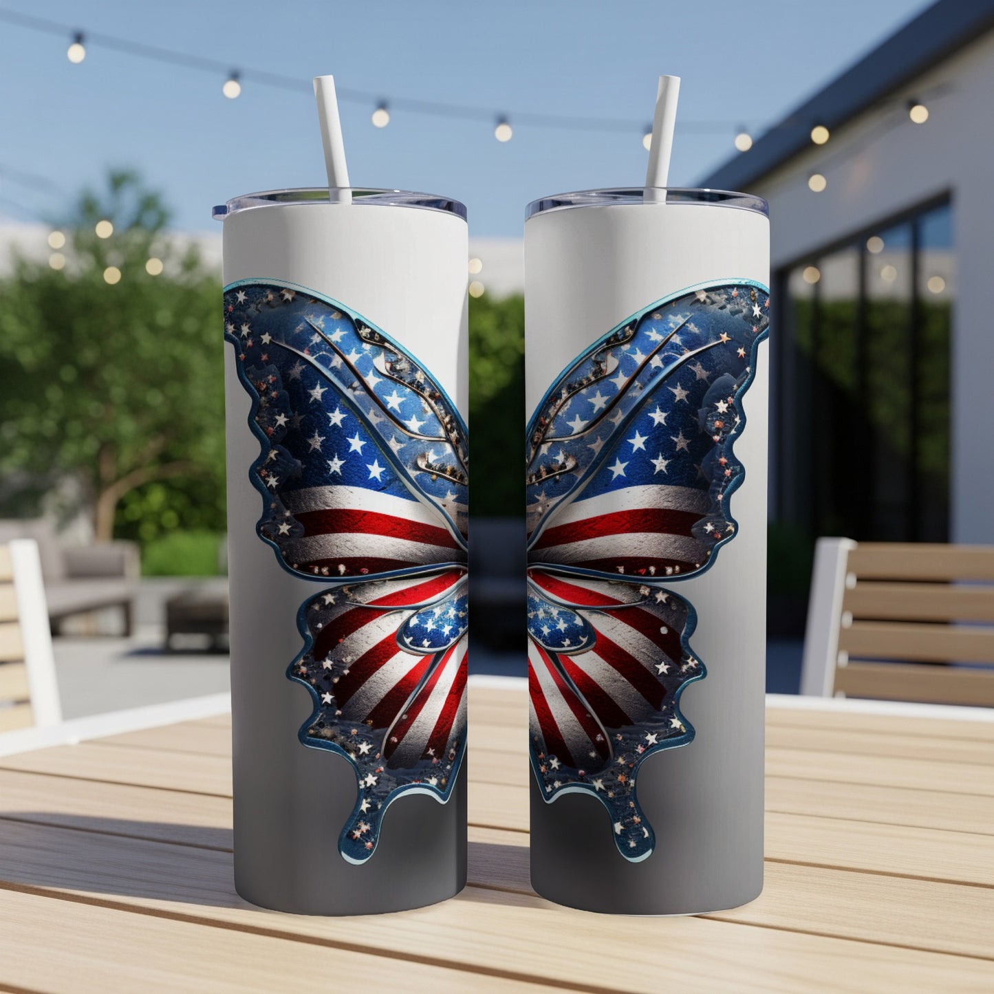 Two tumblers with American flag butterfly design on outdoor table.