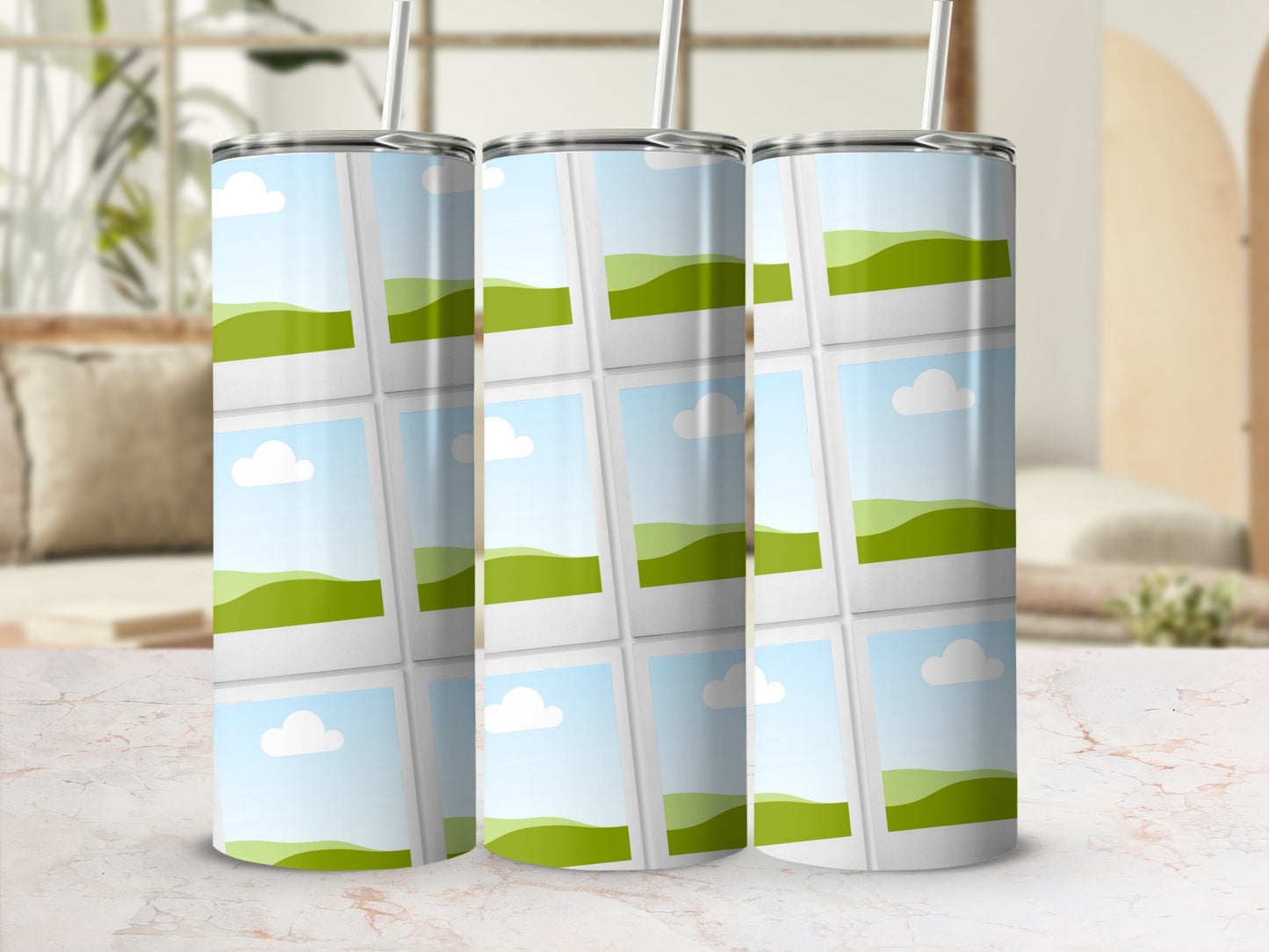 Three tumblers with a landscape photo collage pattern on a marble surface.