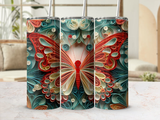 Three tumblers with a red and orange butterfly design on a marbled surface.