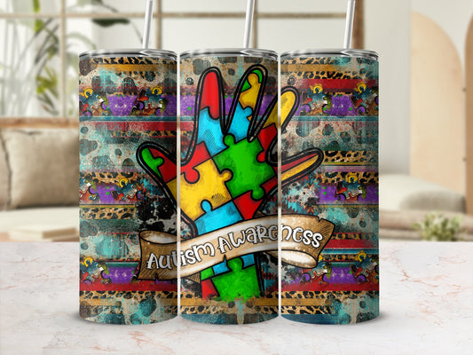 Autism Awareness tumbler with colorful puzzle hand design and leopard print.