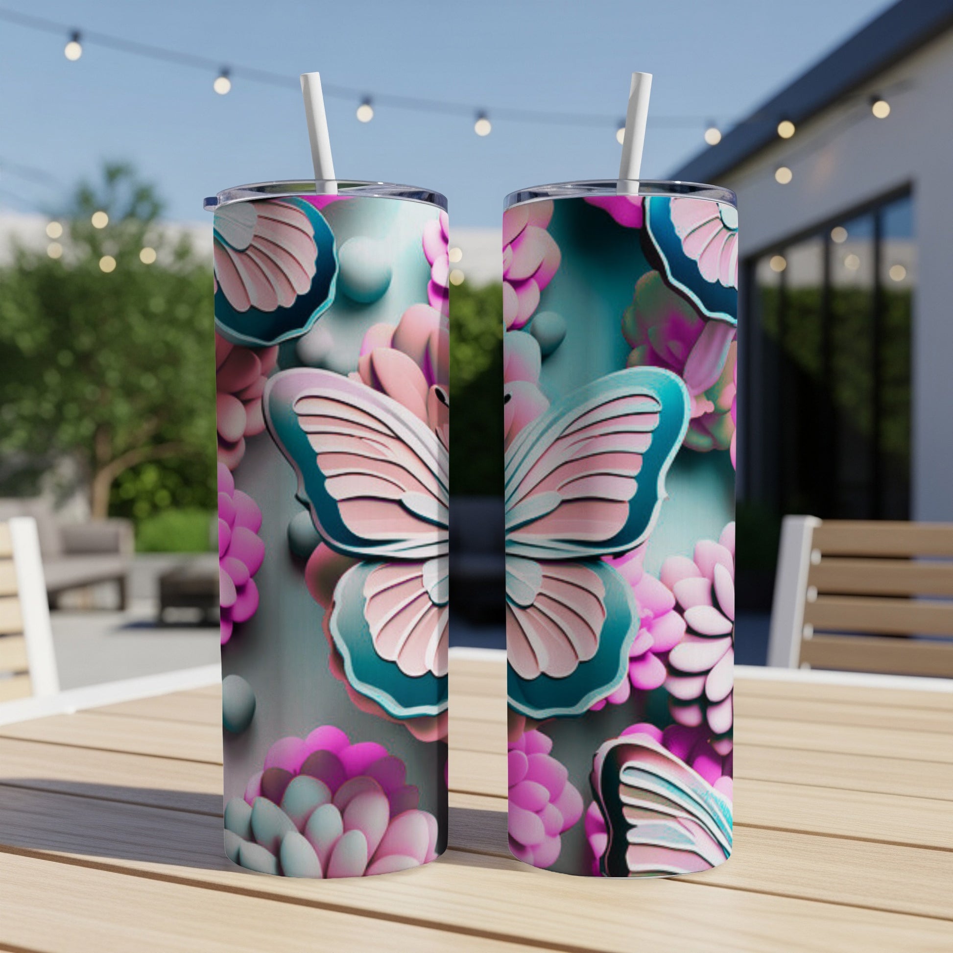 Two tumblers with a butterfly and floral design sit on a wooden table.