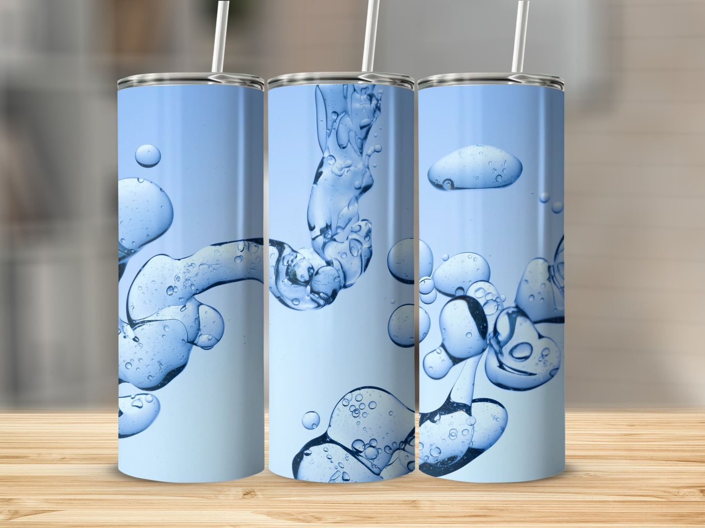 Three tumblers with blue liquid and bubble abstract design.