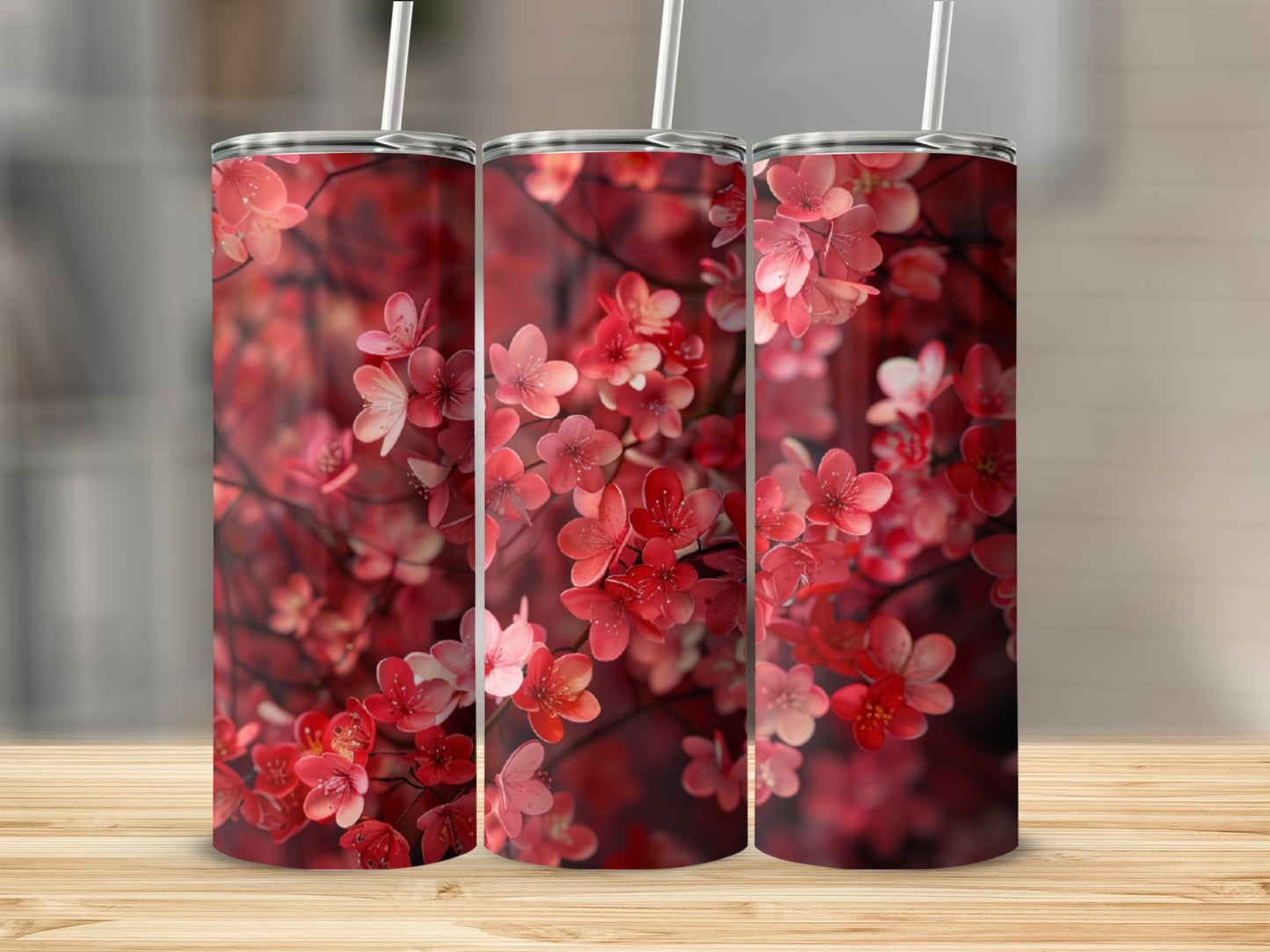 Three tumblers with a floral pattern of pink and red blossoms.
