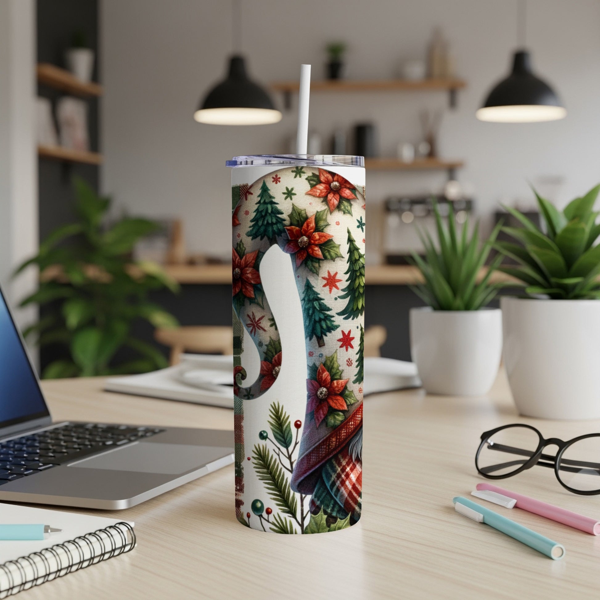 White tumbler with festive floral and Christmas tree pattern.