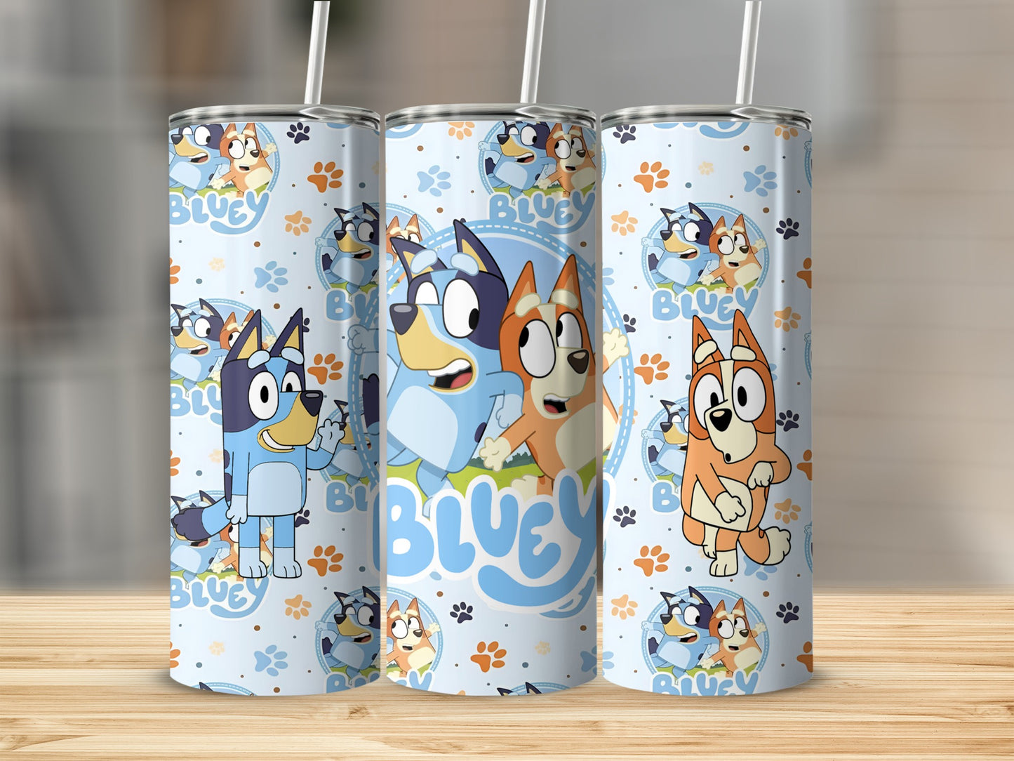 Bluey and Bingo characters on a light blue patterned tumbler with straws.