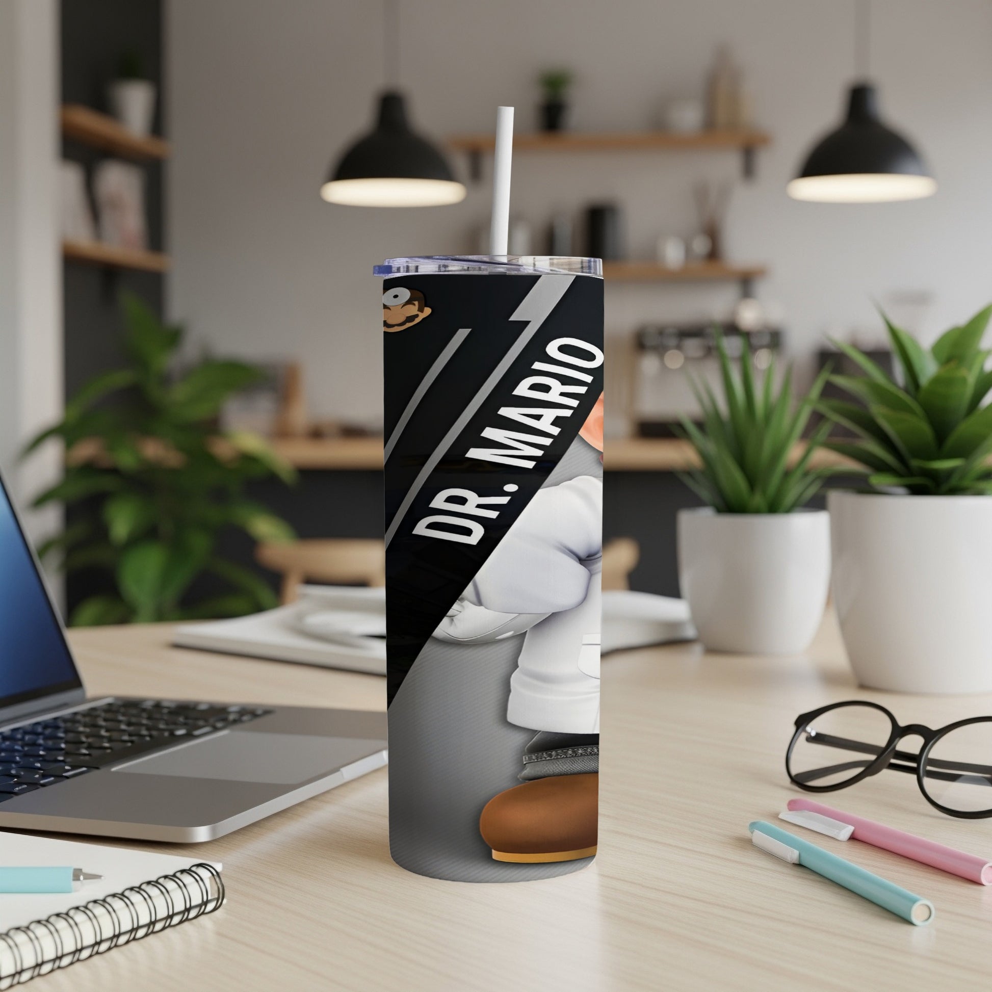 Dr. Mario character on a white tumbler with straw on a desk.