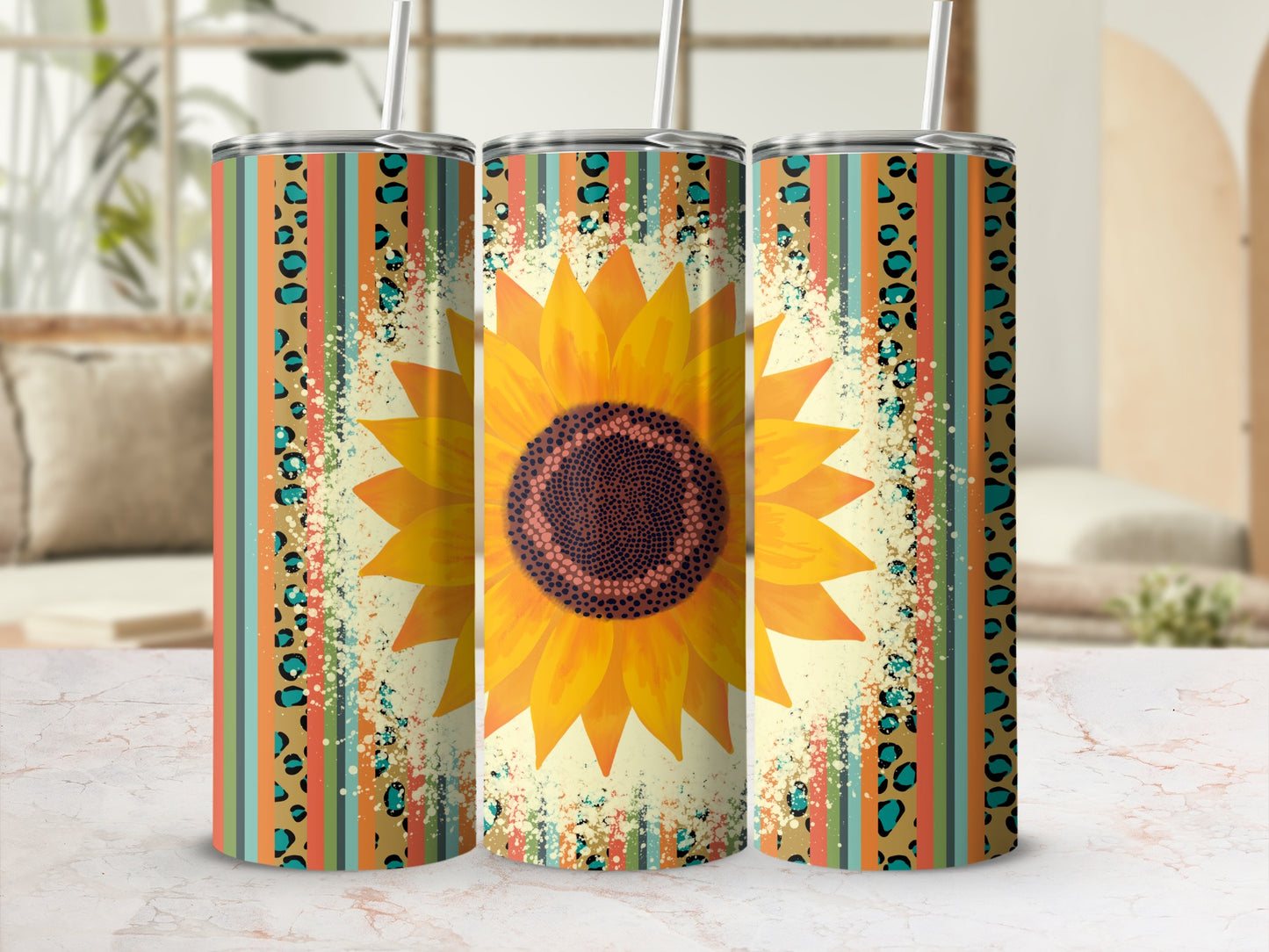 Sunflower and leopard print tumbler with straws, on a marble surface.