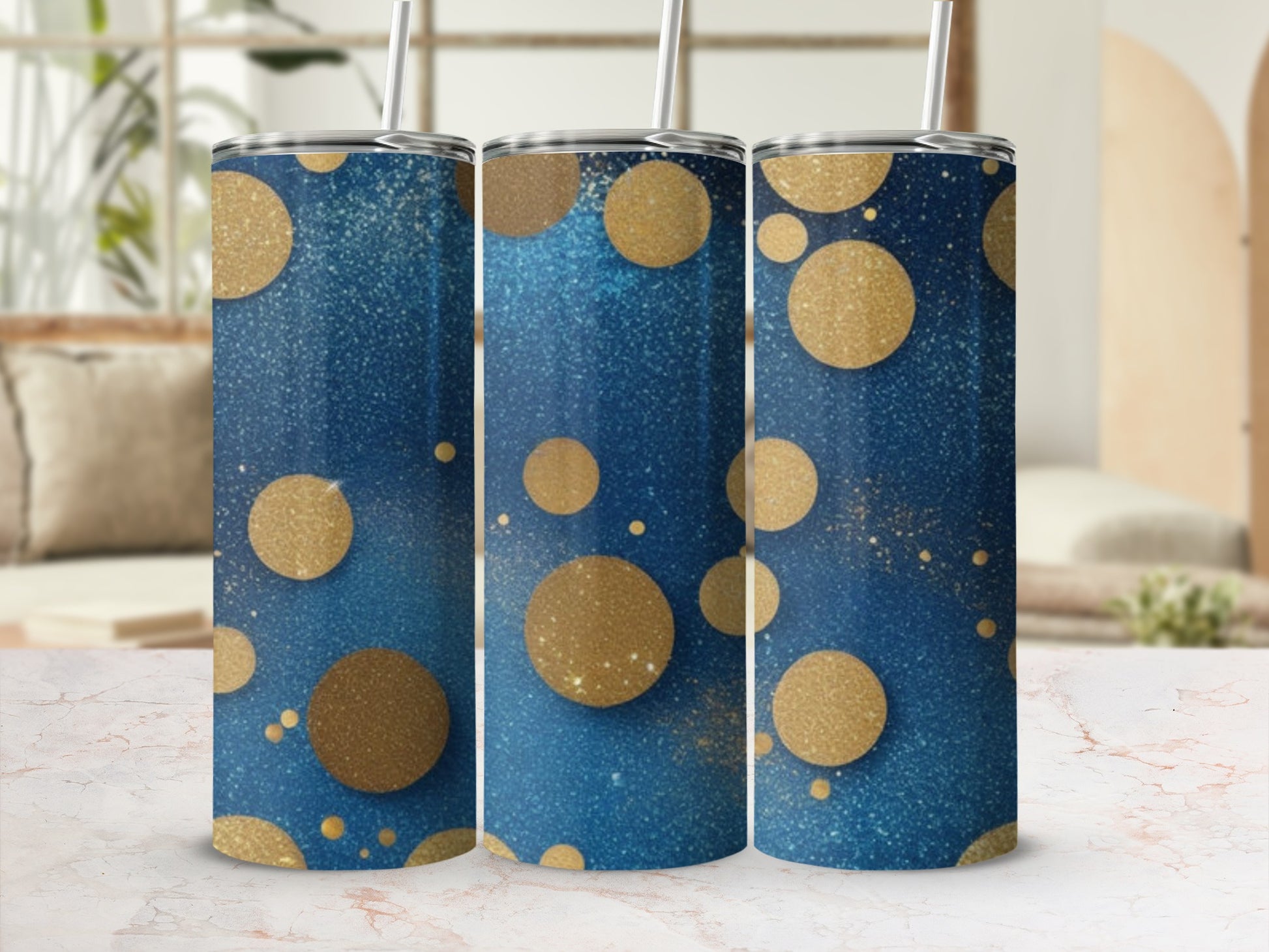 Three blue tumblers with gold glitter and circles, with a straw.