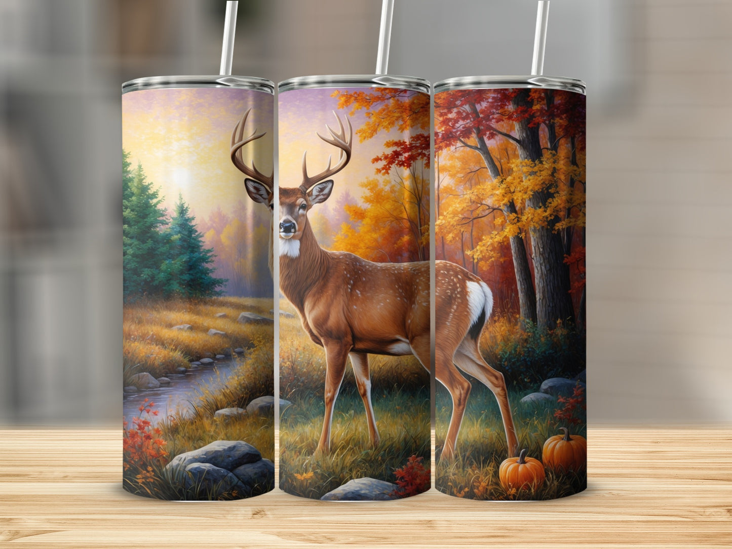 Deer in autumn forest scene on three cylindrical tumblers.
