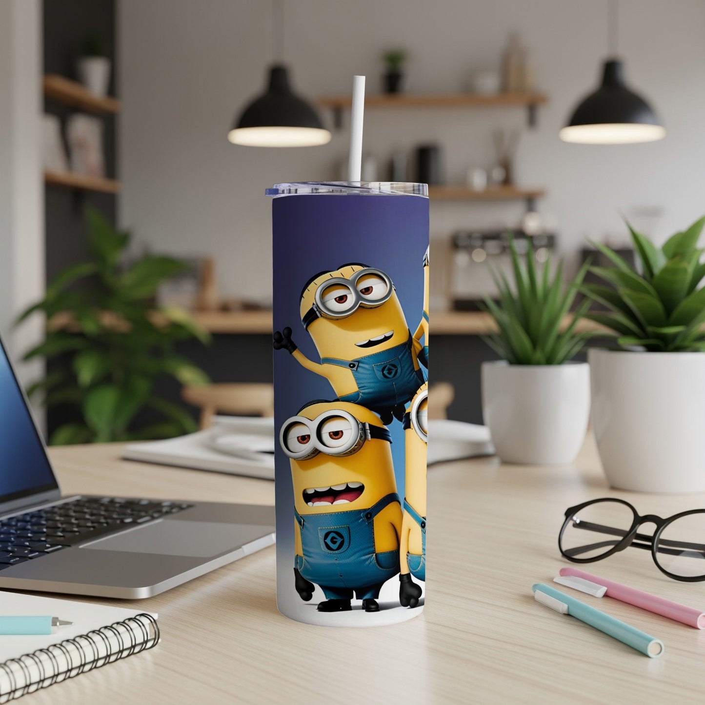 Three Minions stacked on a blue tumbler with a straw.