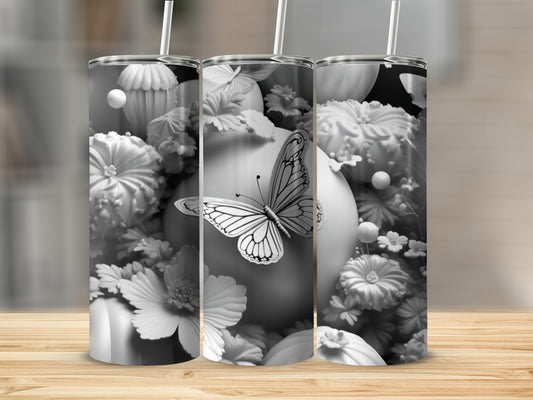 Three tumblers with floral and butterfly designs, displayed on a wooden surface.