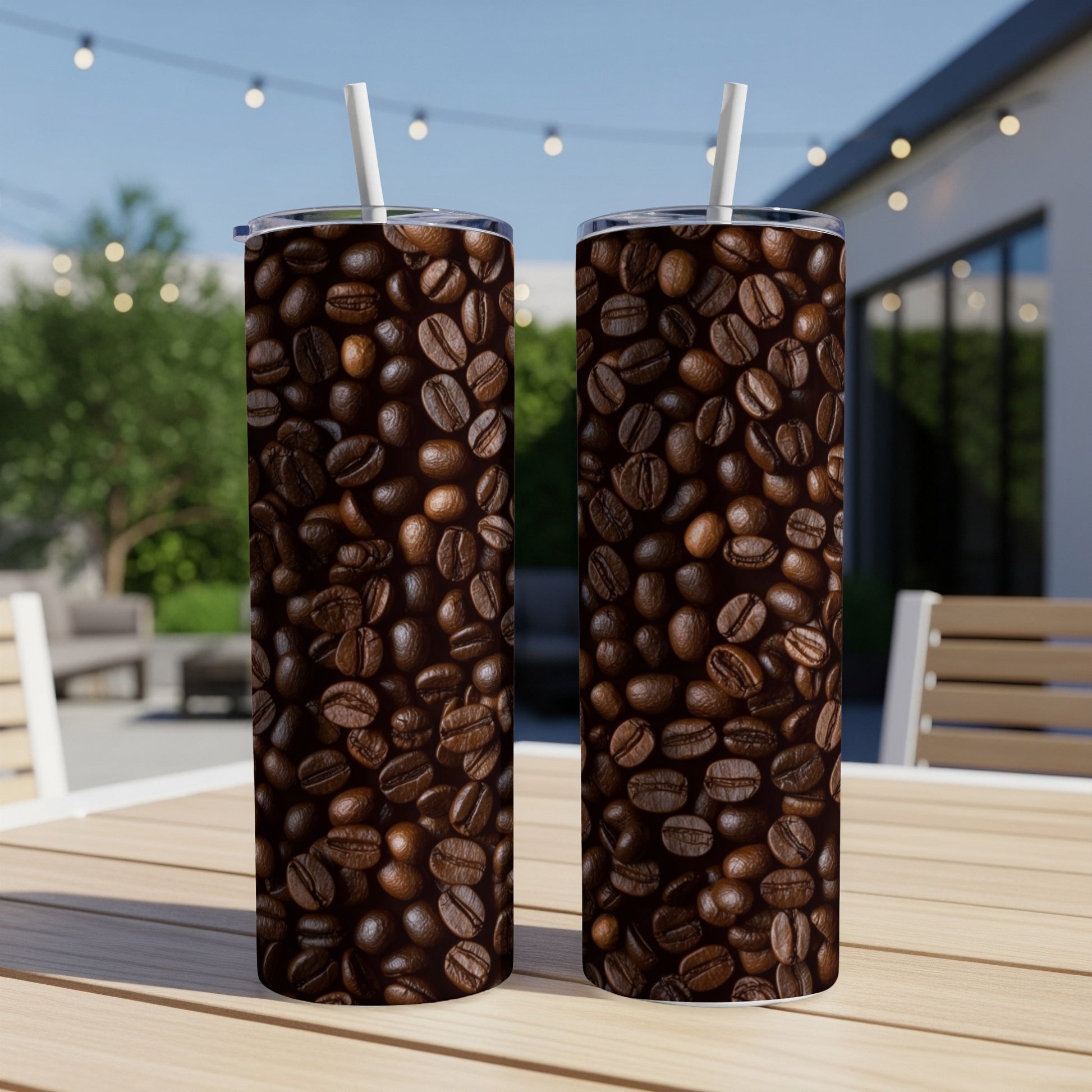 Two tall tumblers with a close-up coffee bean pattern, resting on a table.