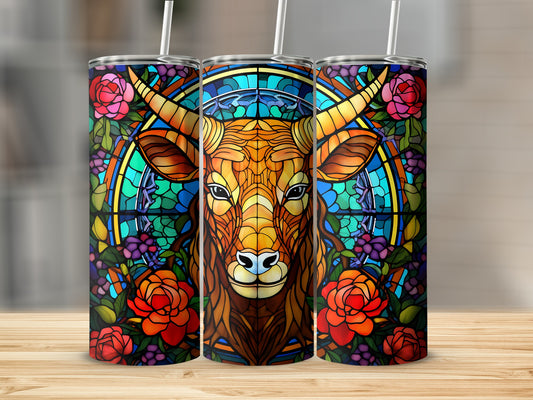Stained glass cow head surrounded by roses and vines on a tumbler.