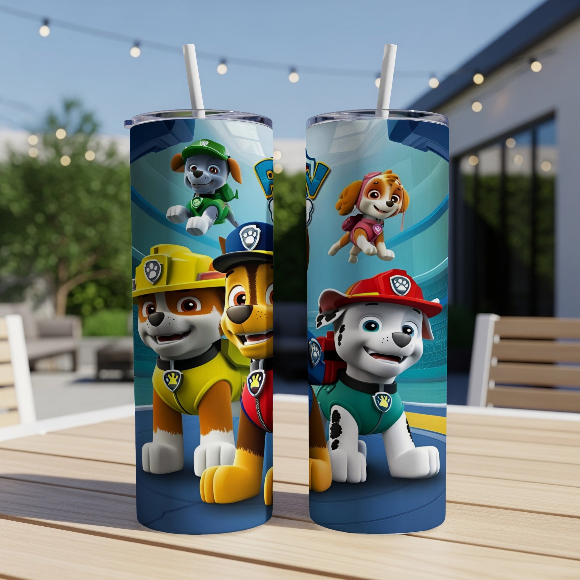 Two Paw Patrol character tumblers with straws on a table.