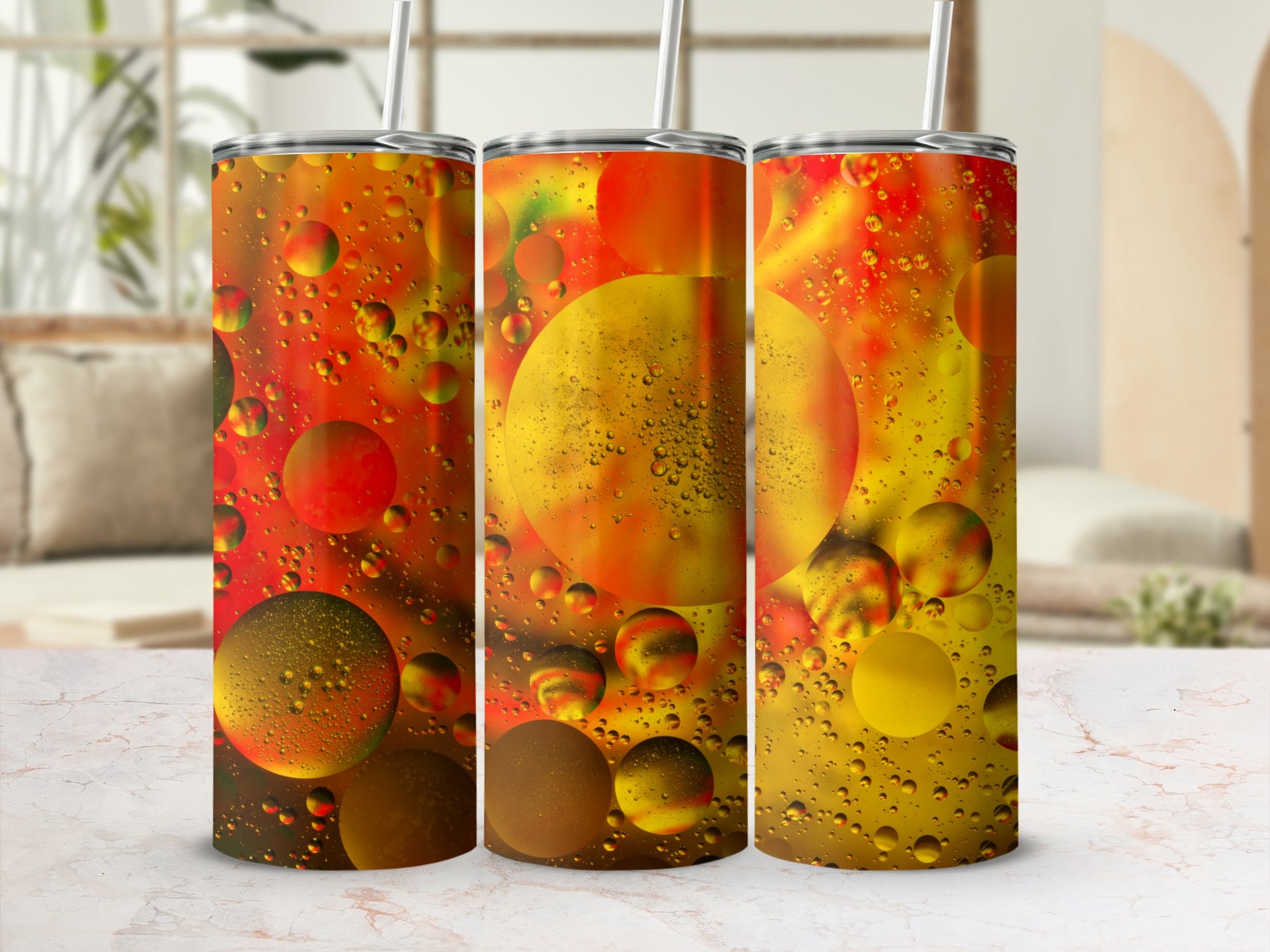 Three tumblers with a colorful abstract bubble design.