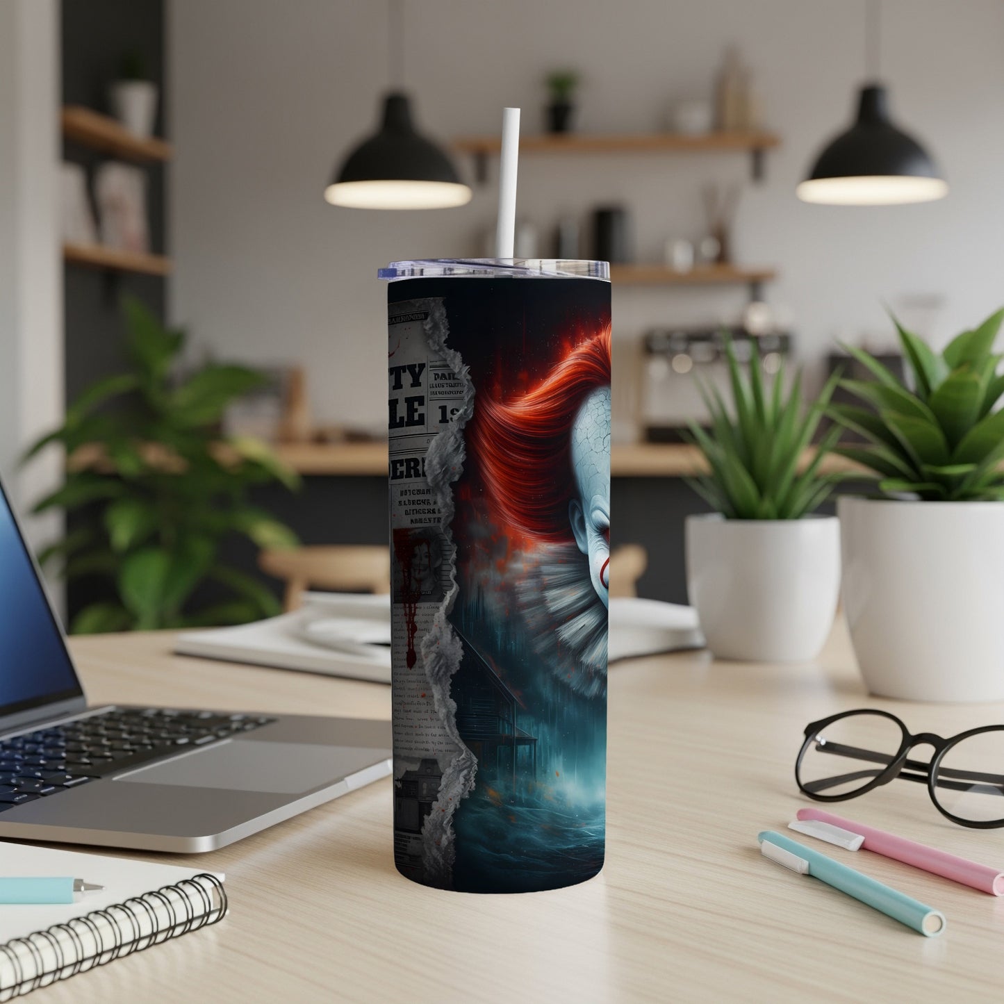 Tumbler with ripped newspaper graphic and creepy clown face with red hair.