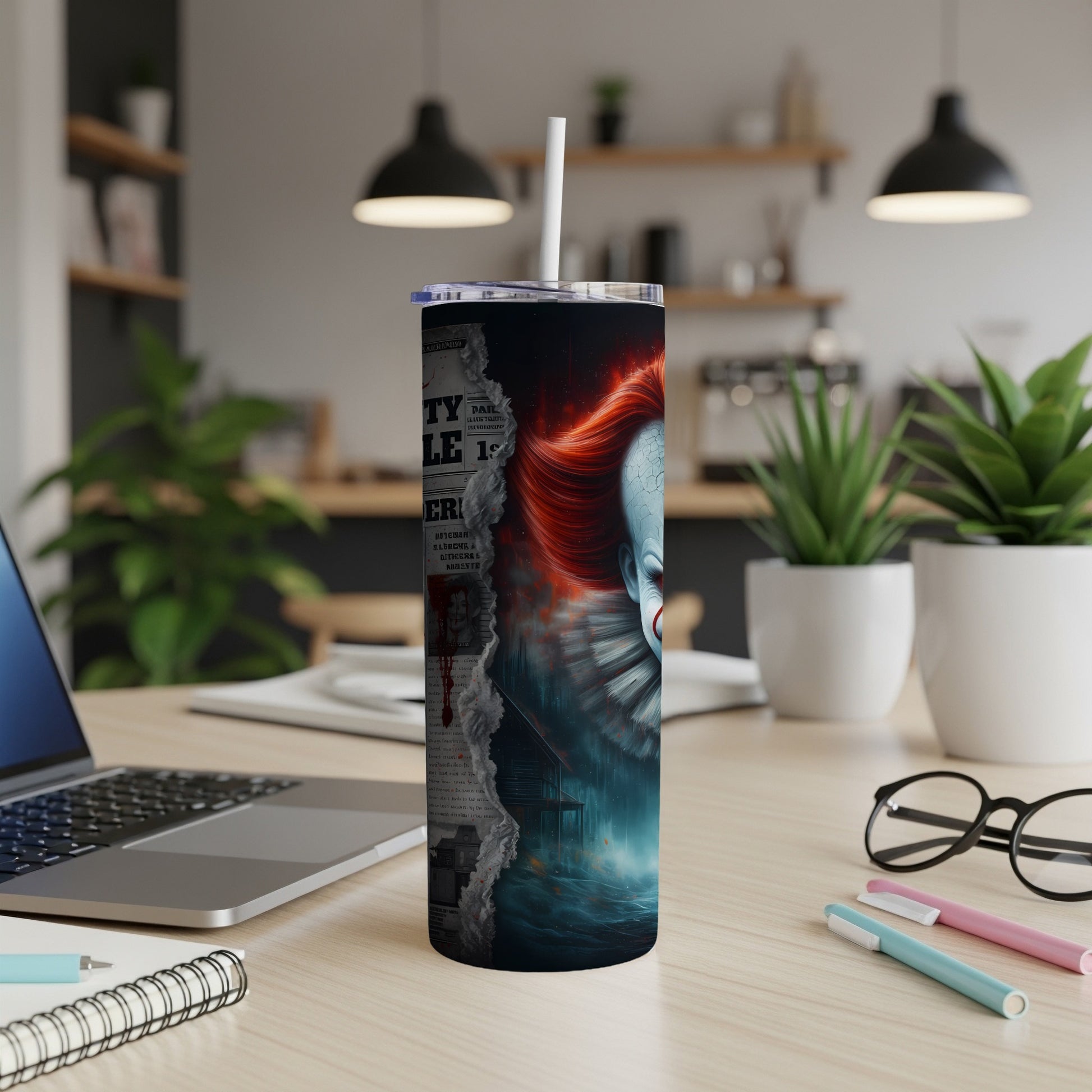 Tumbler with ripped newspaper graphic and creepy clown face with red hair.