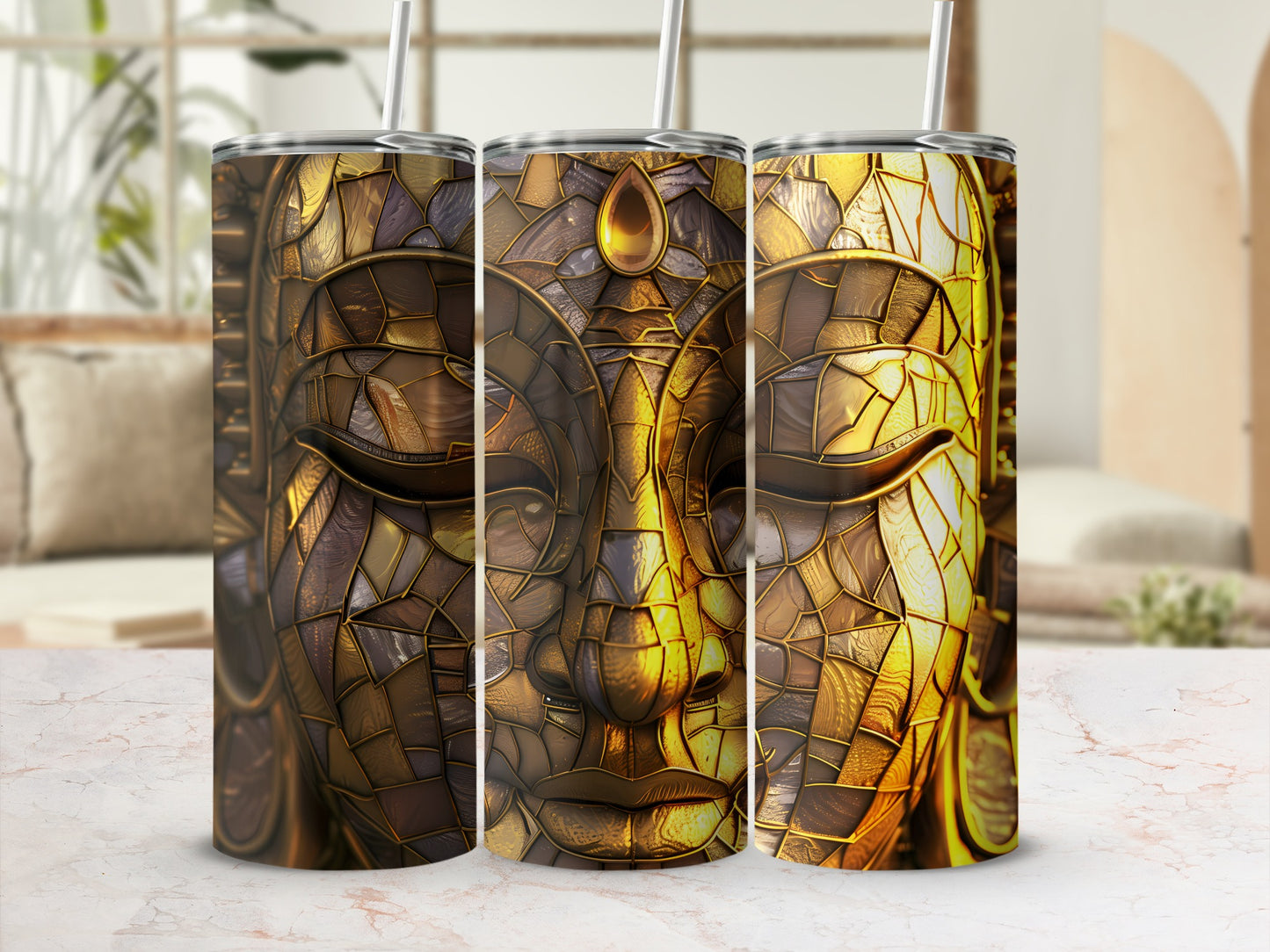 Three tumblers with a gold mosaic Buddha face design.
