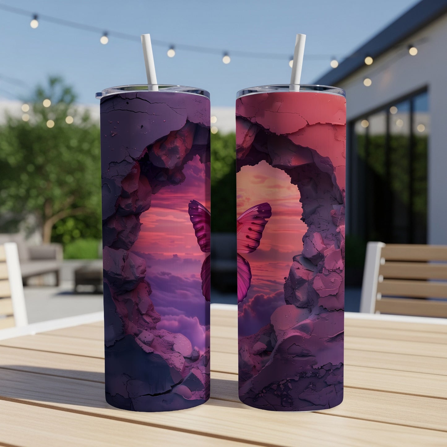 Two tumblers with a butterfly in a cave opening on a patio table.