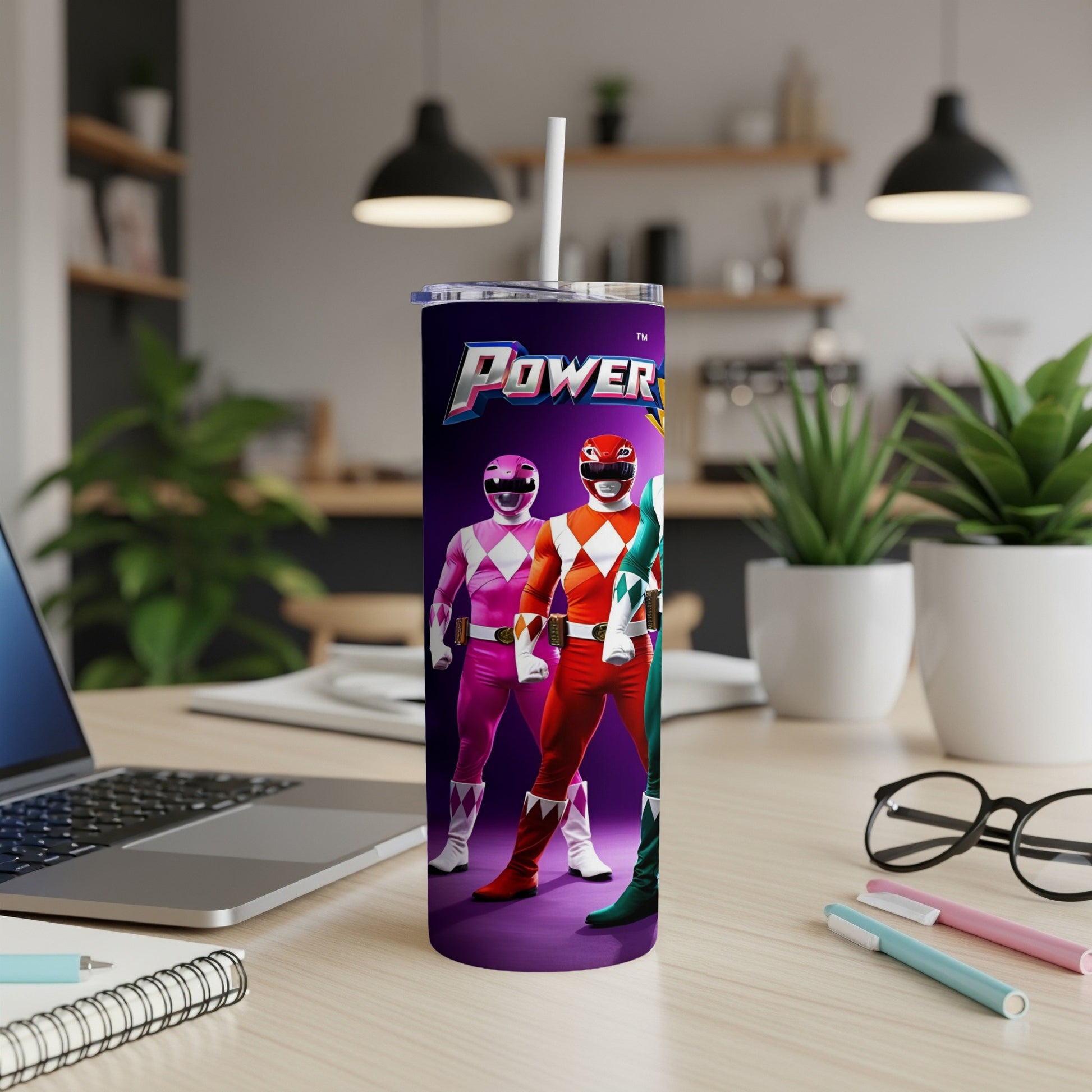Power Rangers standing on purple ground with laptop and desk accessories.