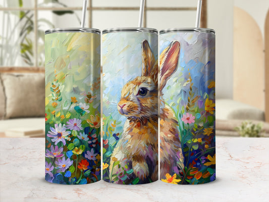 Three tumblers featuring a painted rabbit among colorful spring flowers.