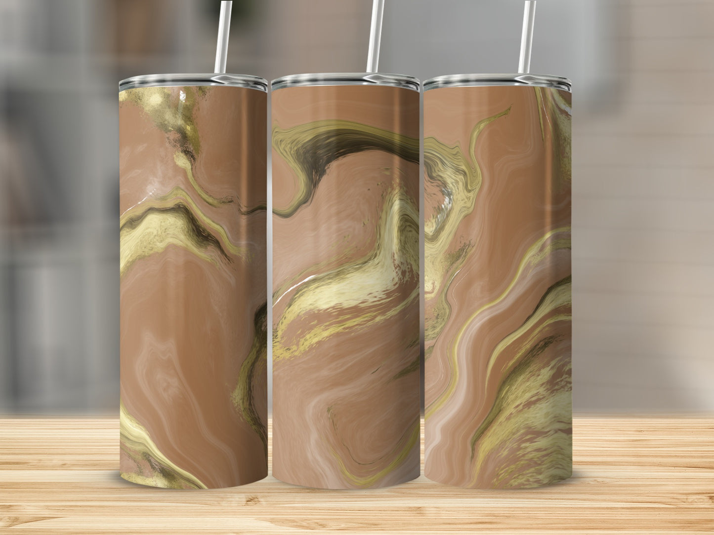 Three tumblers with a marbled brown and gold design stand on a wooden surface.