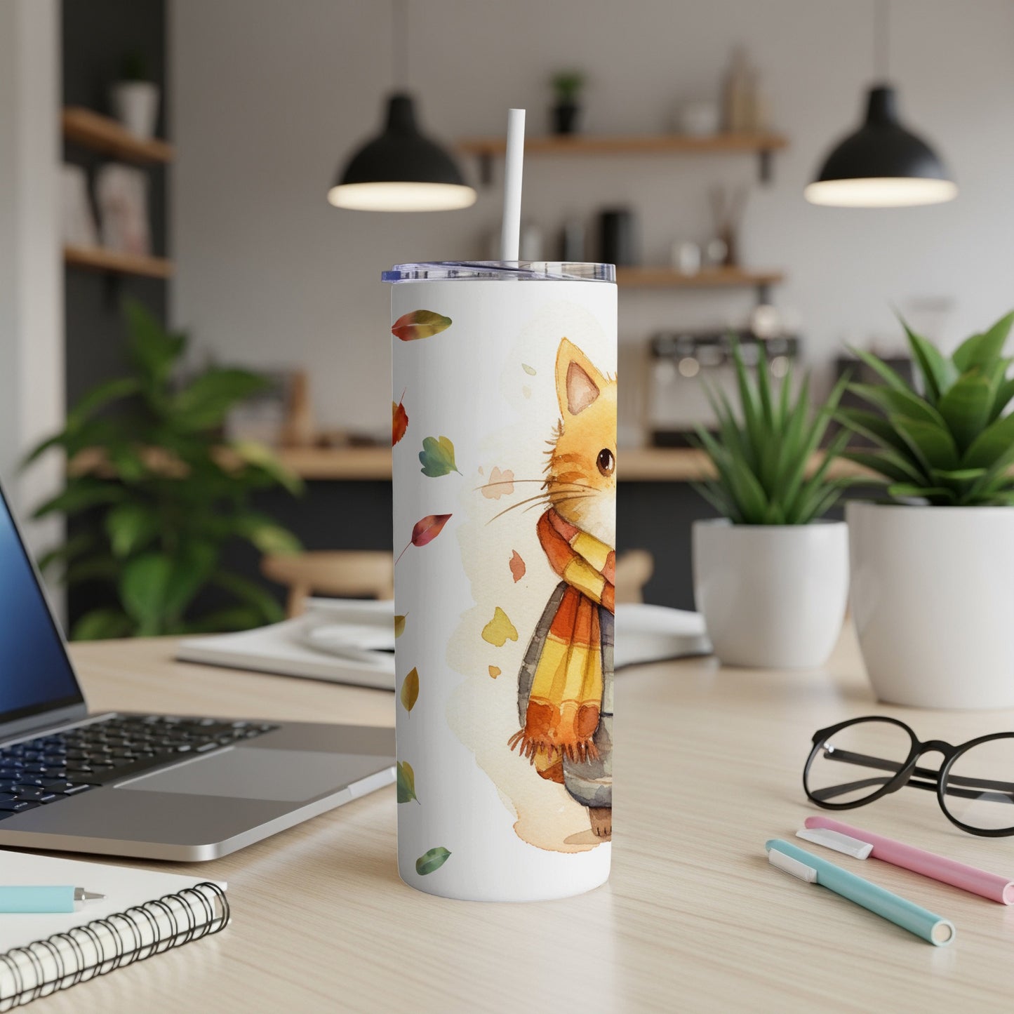 White tumbler with a watercolor cat wearing a scarf and autumn leaves.