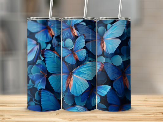 Three blue butterfly tumblers on a wooden surface.
