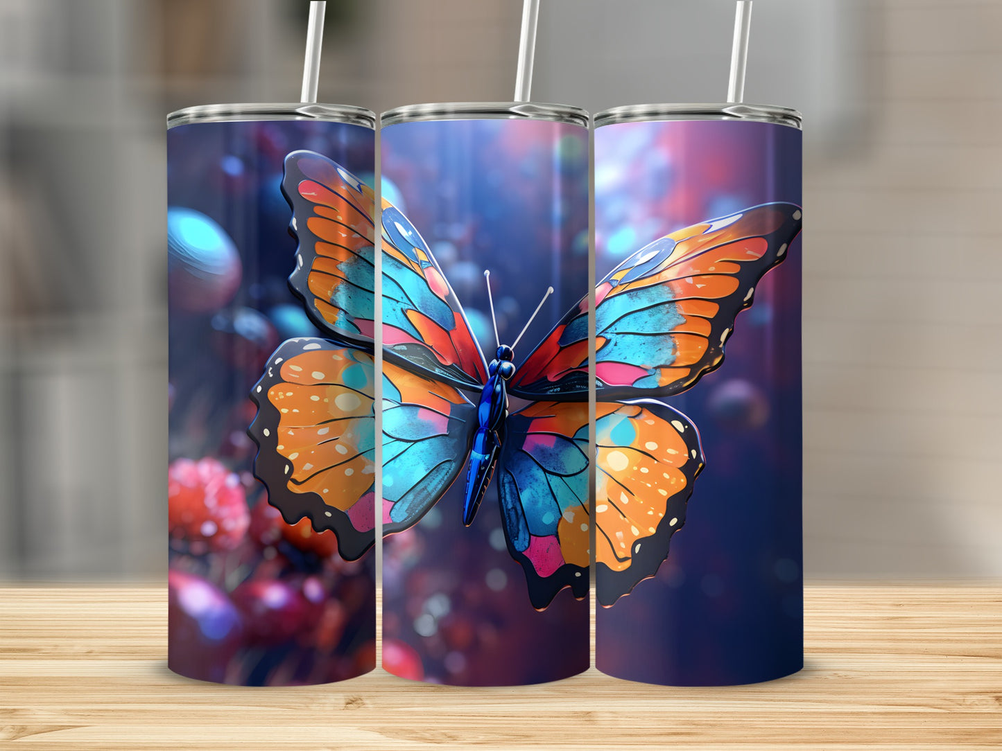 Three tumblers featuring a vibrant butterfly design, placed on a wooden surface.