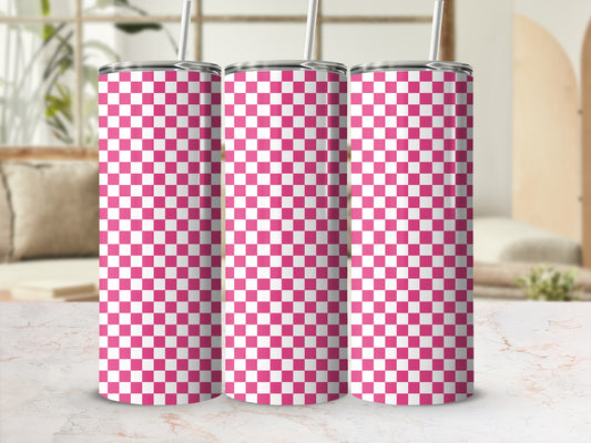 Three pink and white checkered tumblers with straws stand on a marble surface.