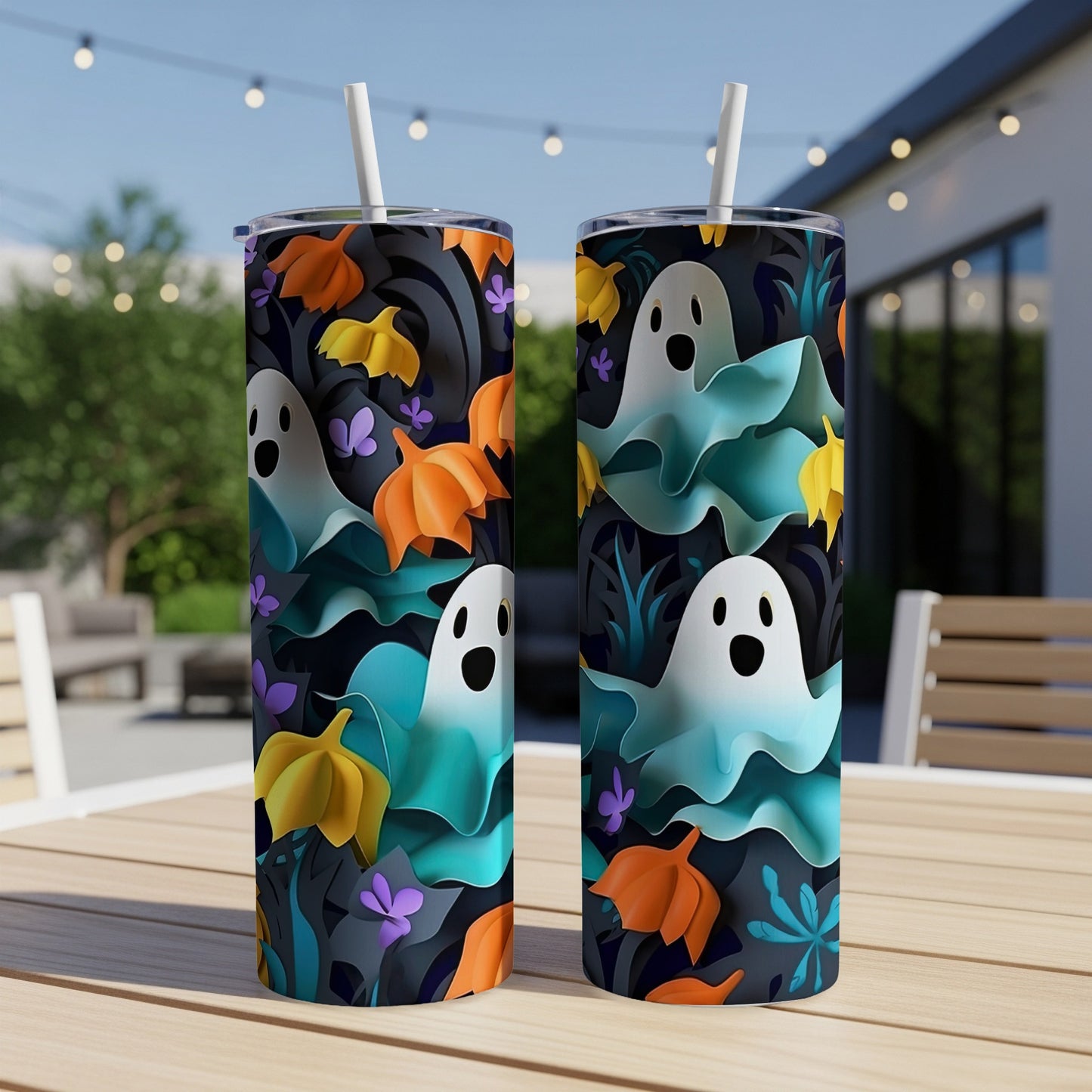 Two tumblers with a Halloween ghost and fall leaf pattern, sitting on a table outdoors.
