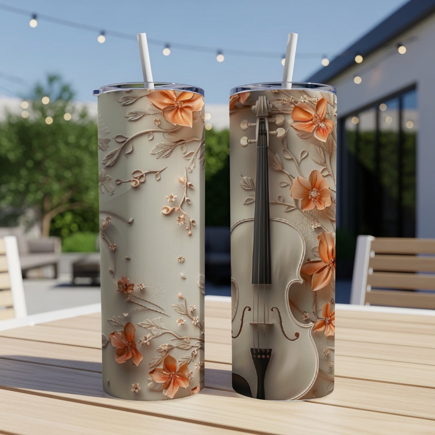 Two tumblers with a floral and violin design sit on a table.