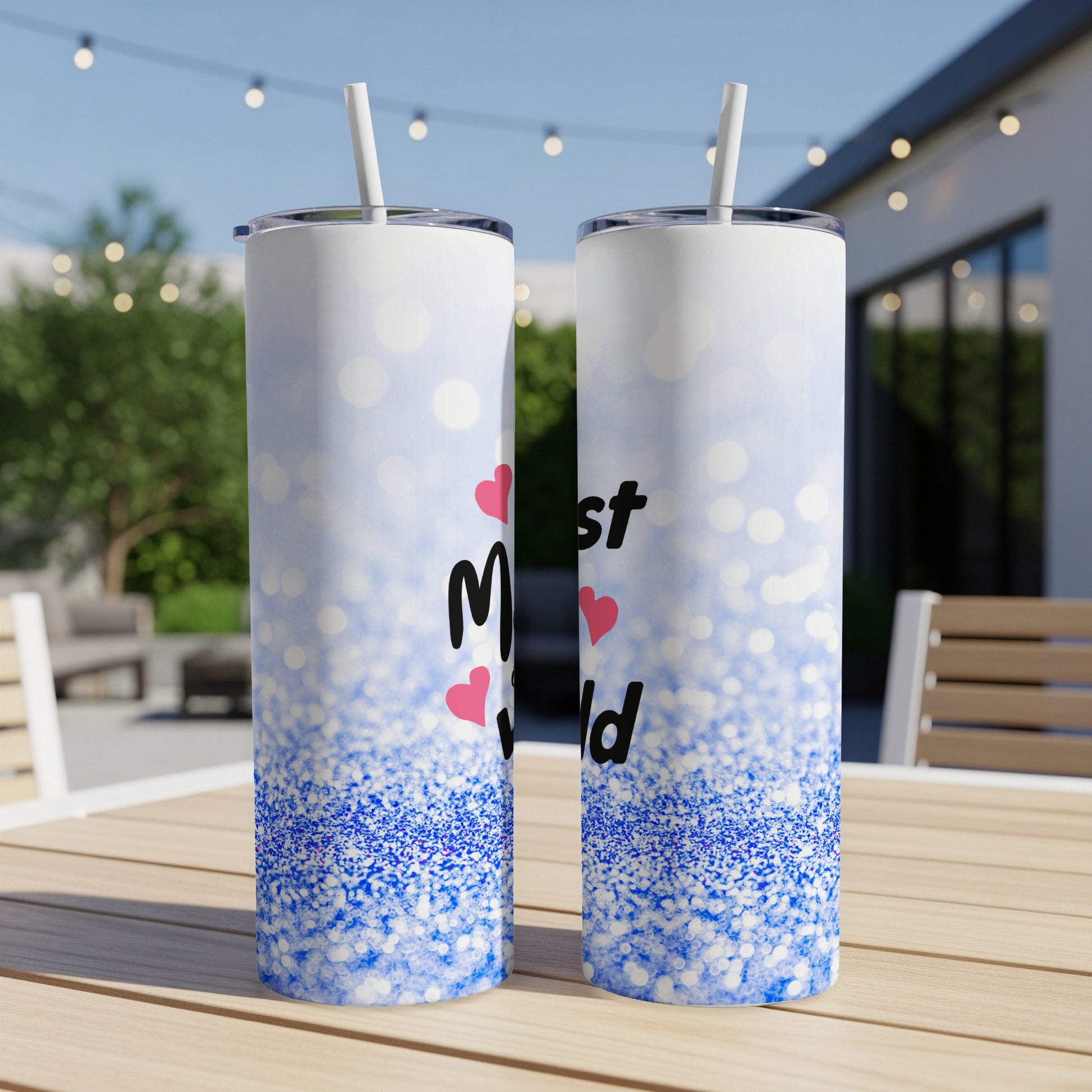 Two skinny tumblers with "Mom" in pink hearts and blue glitter design.