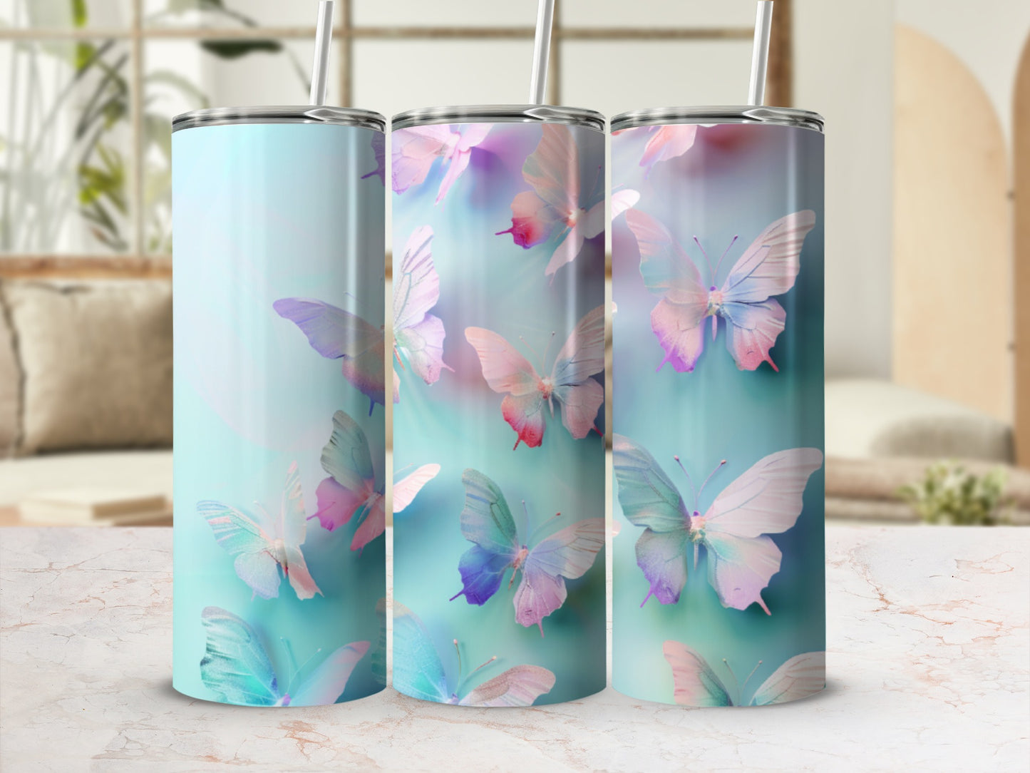 Three tumblers with pastel watercolor butterflies on a light blue background.