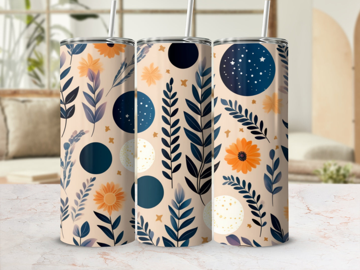Three tall tumblers with floral and celestial patterns on a light background.