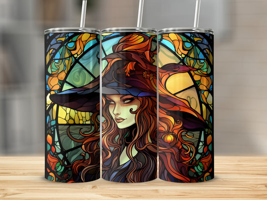 Stained glass witch tumbler with straws on a wooden surface.