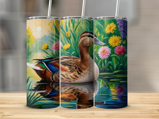 Mallard duck in water with colorful flowers and reflection.