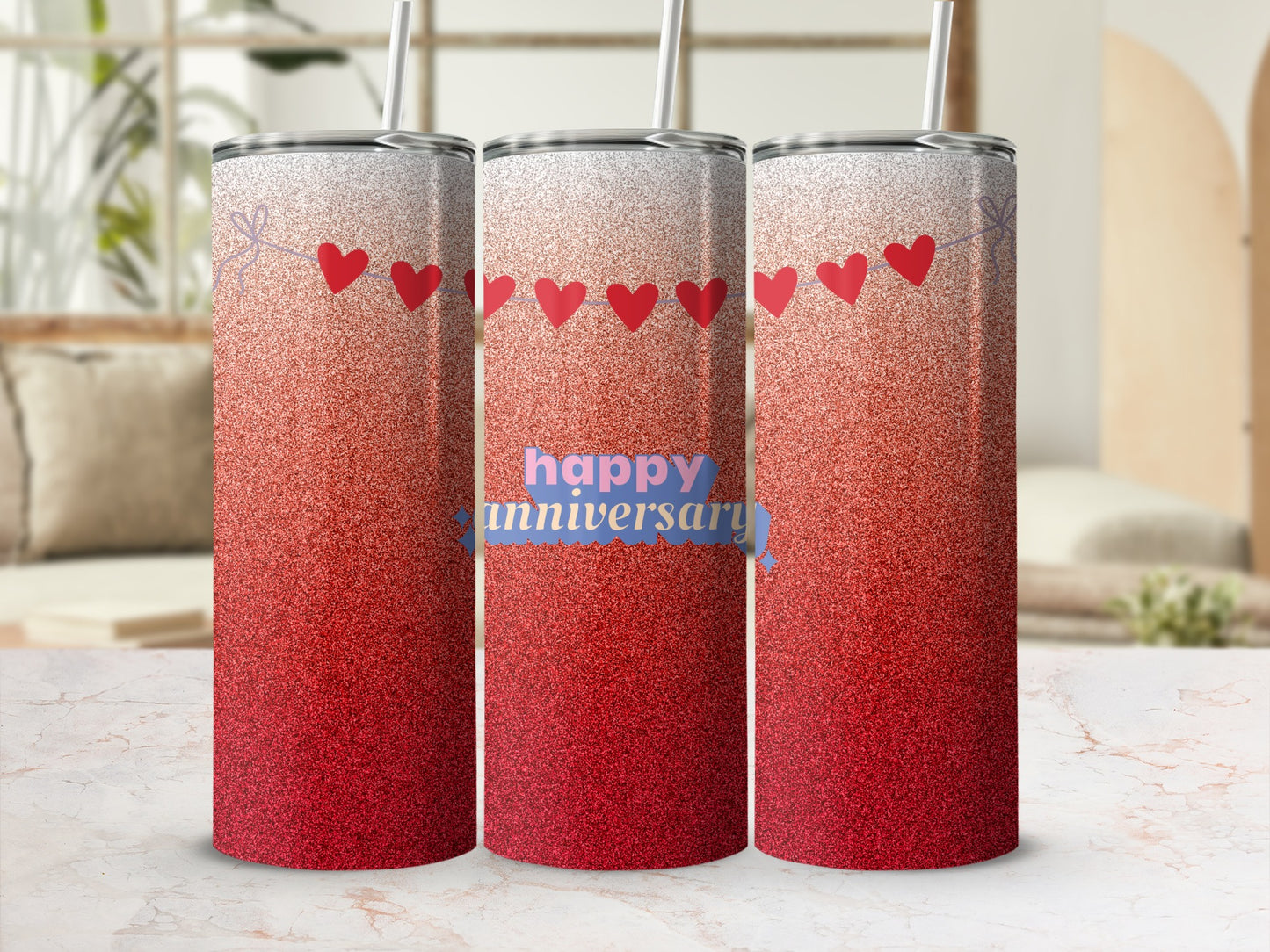 Three red ombre tumblers with heart garland and "happy anniversary" text.
