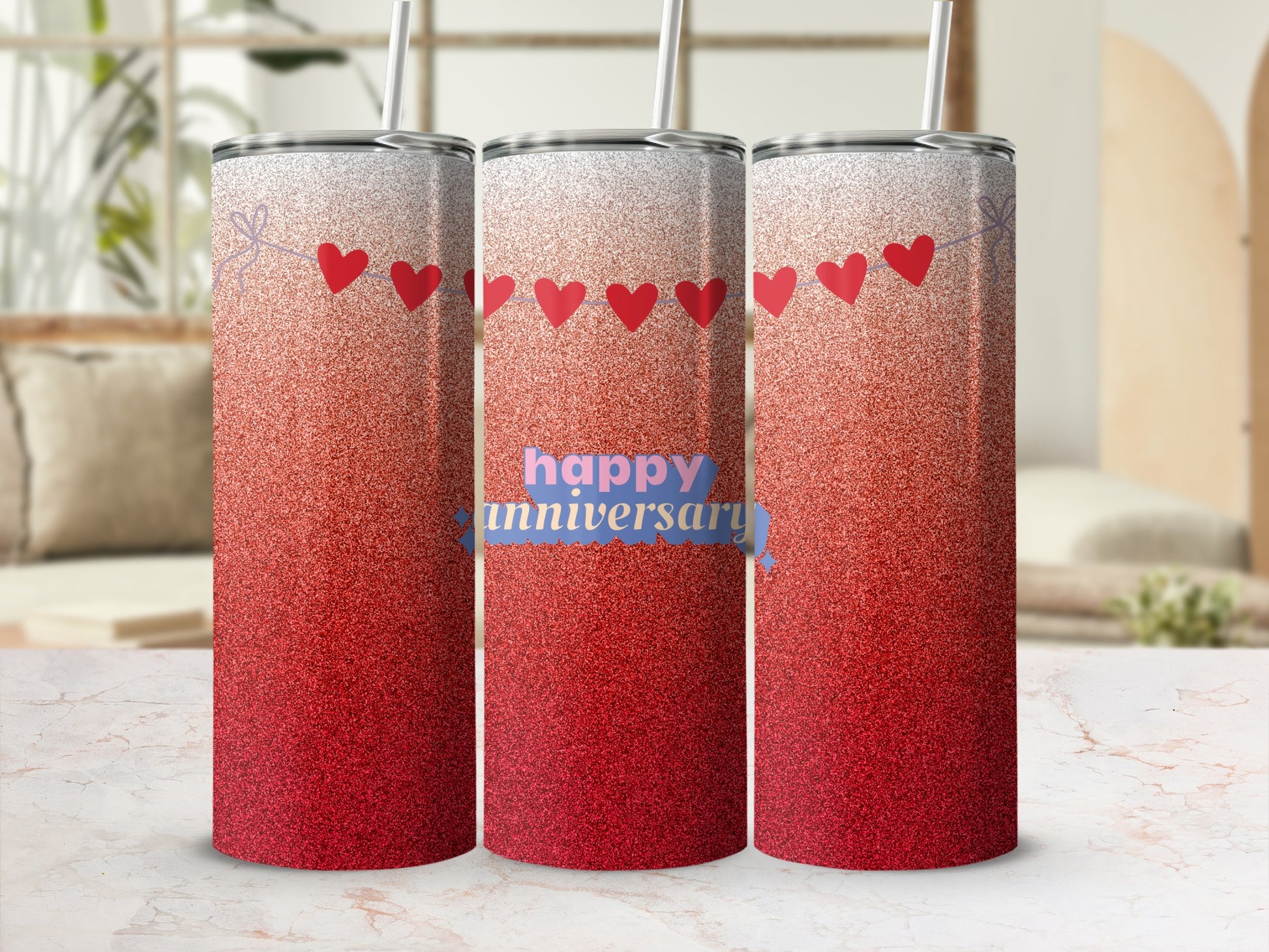 Three red ombre tumblers with heart garland and "happy anniversary" text.
