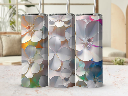 Three iridescent tumblers with a floral pattern sit on a table.